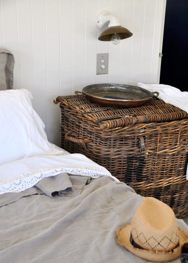 A large woven chest with a lid is a creative and cool idea for storage and to use it as a nightstand is great for a rustic inspired space