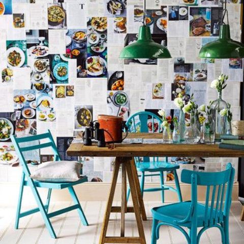 a colorful dining space with blue chairs and green pendant lamps, a wall done with recipes