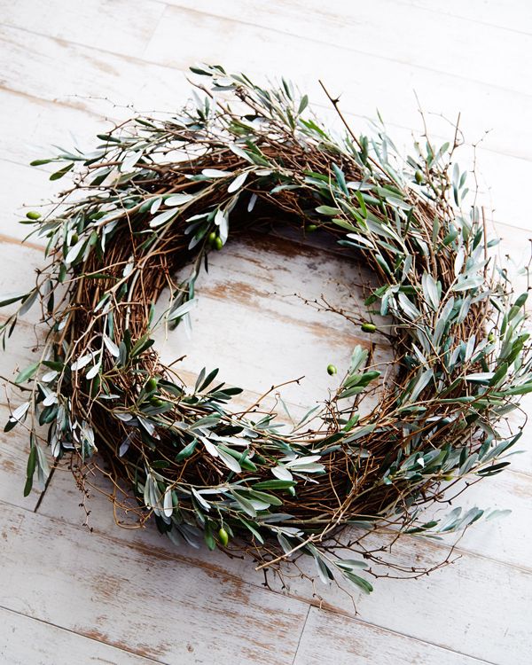 A relaxed fall twig wreath with much olive greenery and olives is all natural and will give a Mediterranean feel to your porch