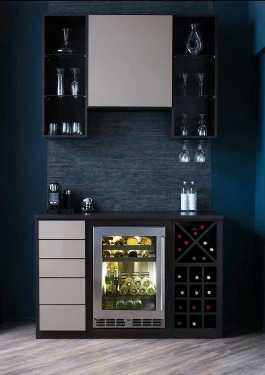A laconic contemporary home bar with open black storage units, a sleek white cabinet and drawers, a wine cooler built in