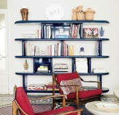a mid-century modern book case made of shiny navy blue panels will add color to your room