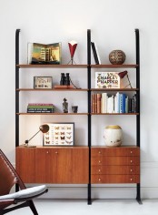 a mid-century modern bookcase of metal and rich-stained wooden shelves and drawers is a stylish idea that doesn’t take any floor space