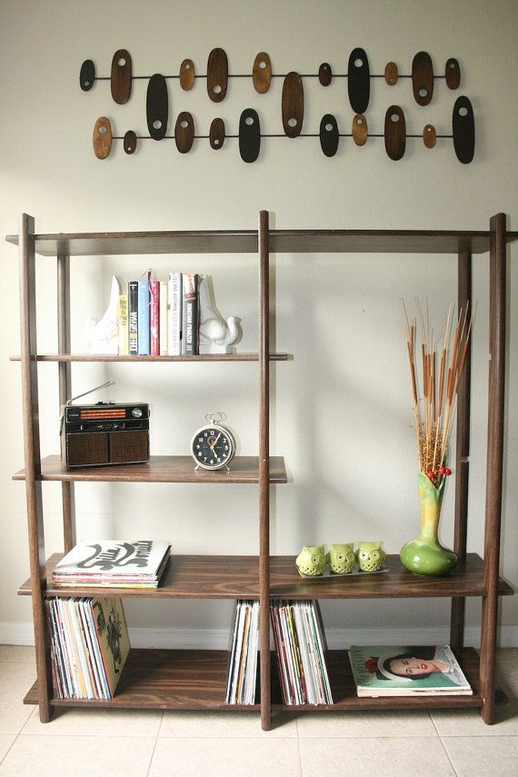 A very simple dark colored wood bookcase with open shelves will fit most of spaces easily