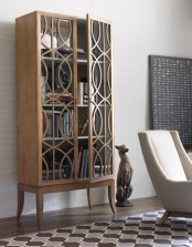 a chic and elegant wooden bookcase with tall legs and patterns made with wood on glass doors