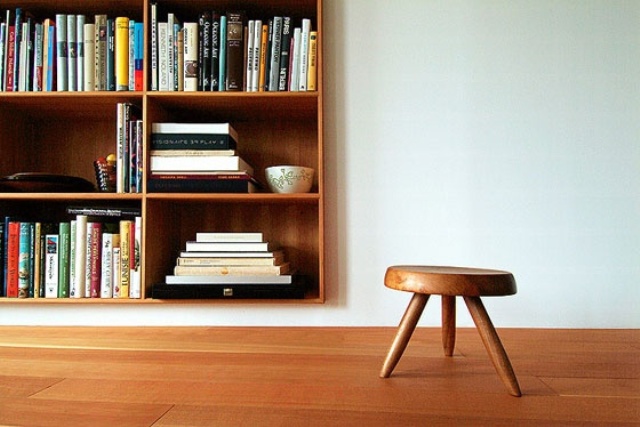 A wall mounted light colored wooden box bookcase is a stylish way to save floor space