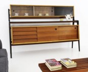 a large stained mid-century modern sideboard with sliding doors and drawers, a shelf with sliding glass doors to display your things