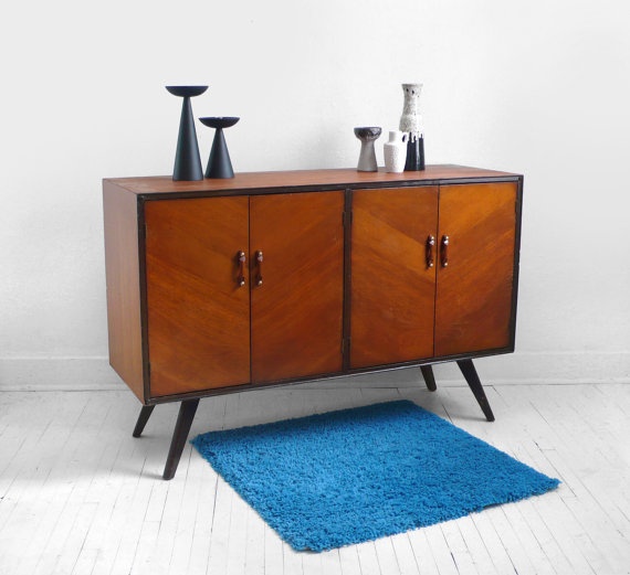 A super simple and cool rich stained mid century modern sideboard with doors, with black framing, handles and legs is a lovely idea for a modern space