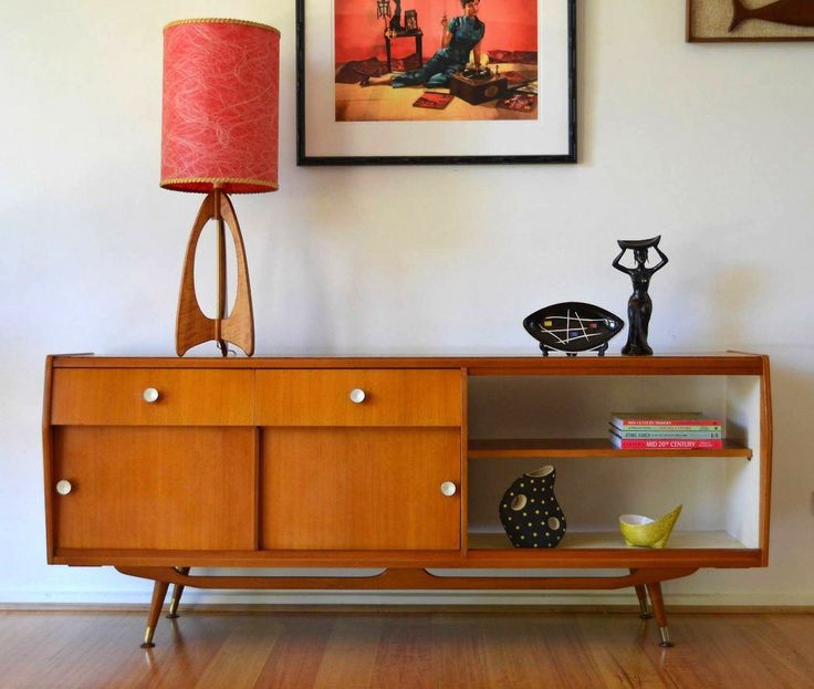 A bold amber stained mid century modern sideboard with an open compartment, a drawer and some doors is a stylish idea for a living room