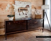 a dark-stained sideboard with sliding doors with cutout handles and on tall legs will make a statement in your space adding color and a contrasting touch if it’s not dark