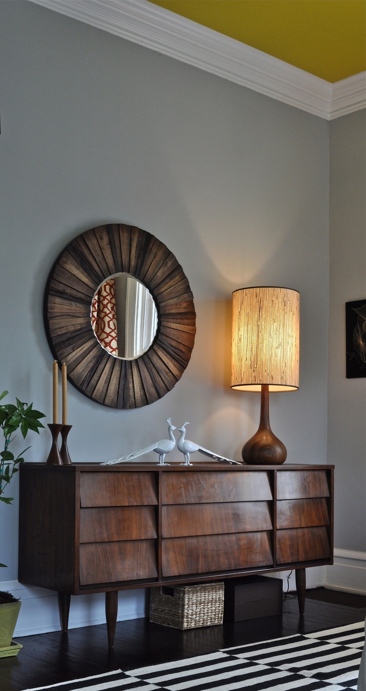 A refined dark stained sideboard with eye catchy covered drawers is a stylish idea for a refined living room or entryway