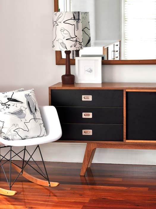 A beautiful mid century modern sideboard with rich stained and black parts, doors and drawers is a lovely idea for adding retro chic to your space