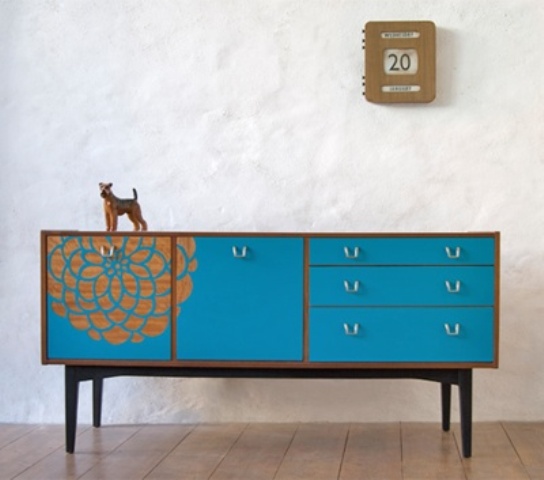 A blue sideboard in mid century modern style, with doors, drawers and a floral stencil is a chic idea and a touch of color to the space