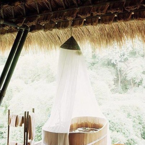 a wooden soak bath with a canopy on top is all you need for ultimate relaxation