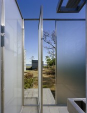 an ultra-modern outdoor shower completely done with frosted glass