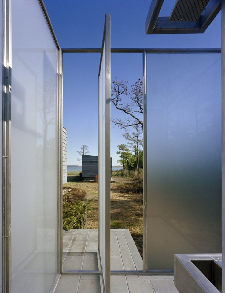 An ultra modern outdoor shower completely done with frosted glass