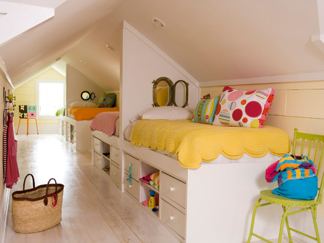 Playful attic hideaway for four kids. All beds features lots of storage under them.
