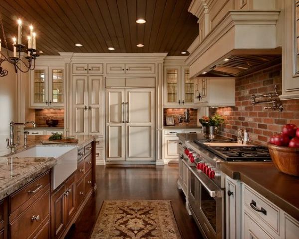 a neutral kitchen with shaker style cabinets, a red brick backsplash, a stained kitchen island with a stone countertop and vintage appliances