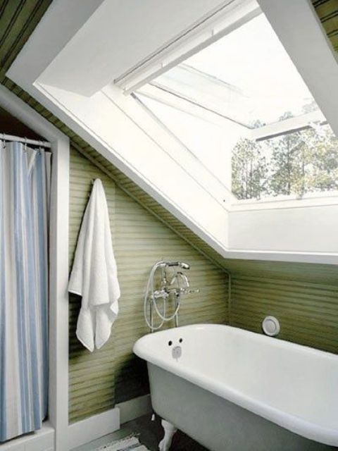 a green attic bathroom with a vintage feel, a clawfoot tub and a shower space with a striped curtain
