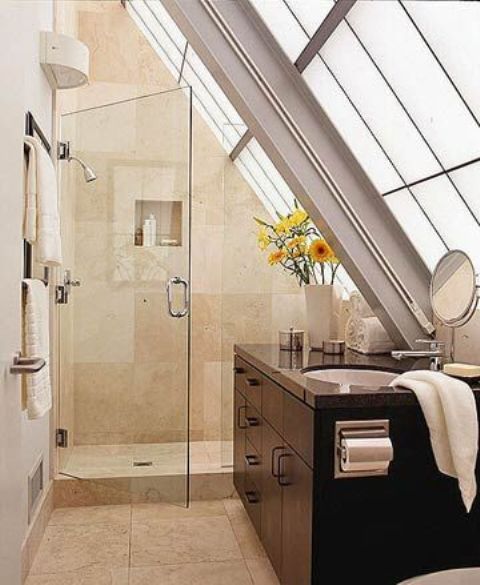 a neutral attic bathroom with a glazed wall, a tiled shower space and a dark vanity