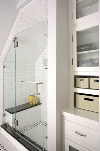 a neutral bathroom with closed storage drawers and units, subway and penny tiles in the shower space