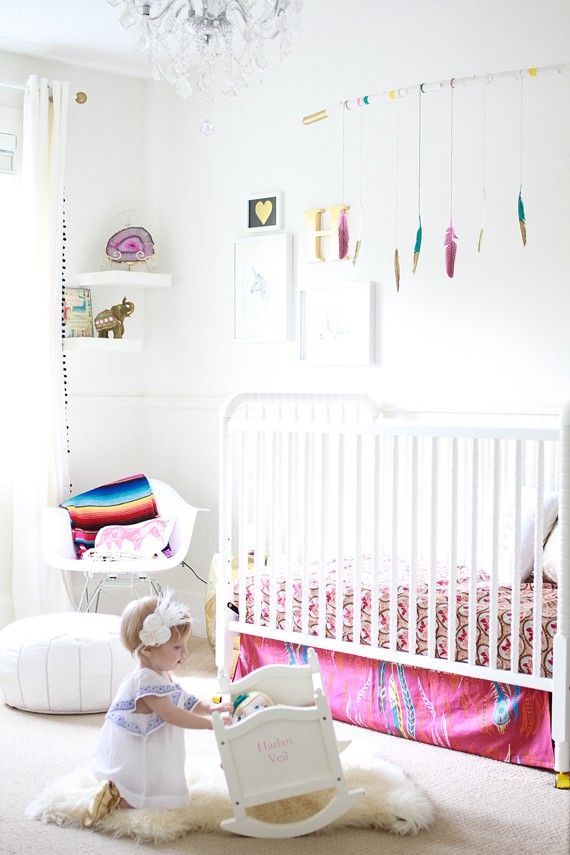 A neutral nursery spruced up with bold colors, with modern white furniture, colorful textiles and toys is a pretty and lovely kid's space