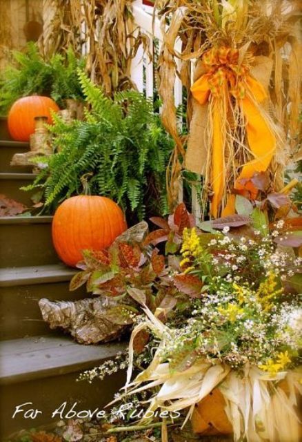 Mixing dried leaves and twigs with fresh greenery and pumpkins is an interesting idea to add some color to your porch's decor.