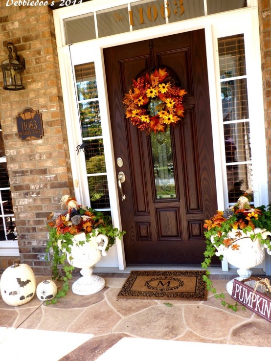 Plant seasonal blooms in creative planters and place them from both sides of the front door.