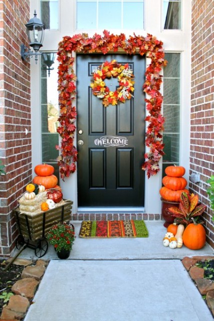 Welcome your guests with a chalkboard door and faux leaves garland over it. 
