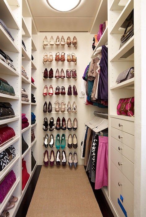a modern neutral closet with open storage units and drawers and a large open shoe shelf in the center is a cool and bold idea
