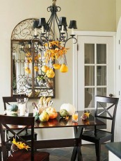a table decorated with natural pumpkins and gourds looks very stylish and very fall-like
