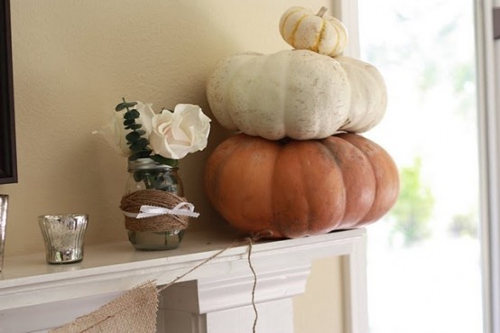 a stack of natural pumpkins is a cool fall decoration for a mantel, table, console or some other space