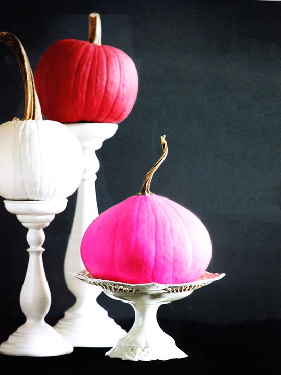 A white, red and pink pumpkin on a stand are bold and non typical fall decorations for a modern home