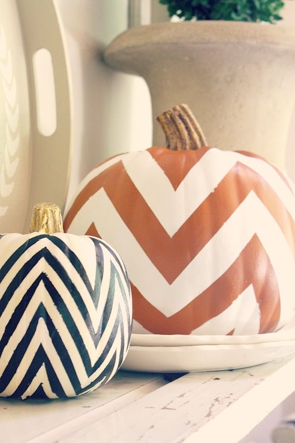 Two pumpkins with orange, black and white chevrons can decorate any mantel in a stylish mid century modern way