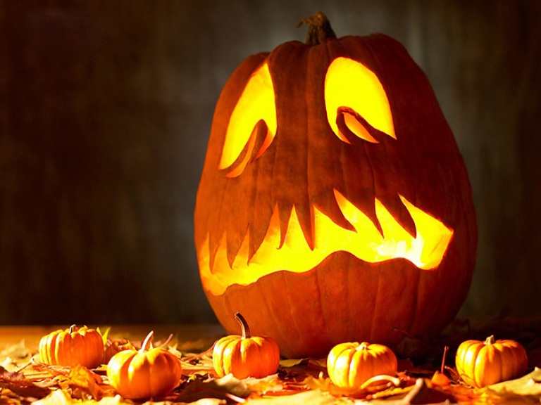 A scary carved Halloween jack o lantern is a creative idea for Halloween home decor and can be used outdoors, too