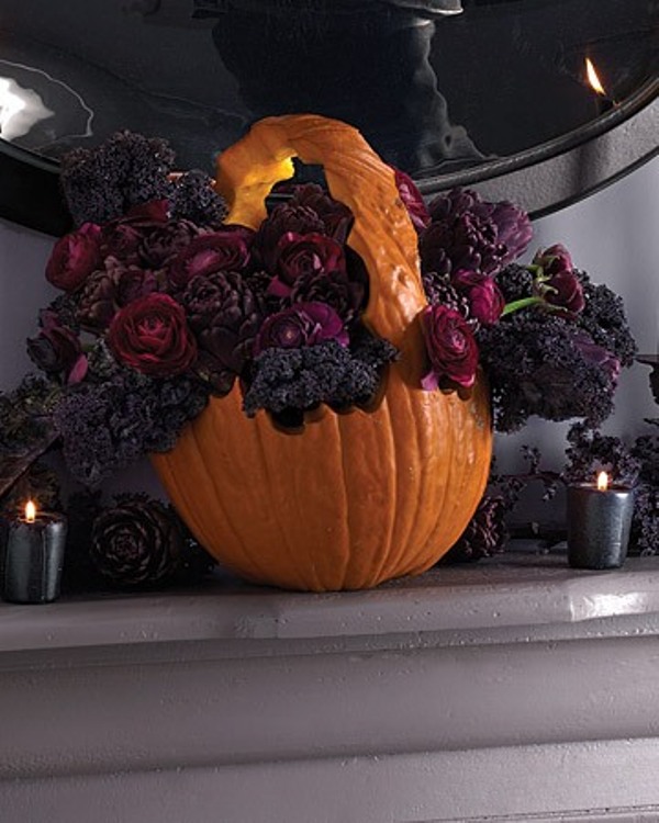 A pumpkin carved and filled with dark blooms is a very stylish and decadent decor idea for Halloween and it looks fantastic