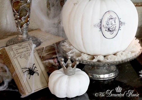 refined white Halloween pumpkins decorated with a black decal and a little crown for chic and beautiful Halloween decor