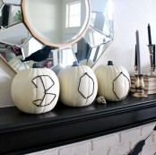 white pumpkins decorated with nails and black yarn are amazing for Halloween and such a craft won’t take much time
