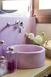 a chic bathroom nook with a lavender round sink and backsplash and contemporary hardware looks very girlish and cute