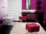a bright contemporary space done with fuchsia, purple, black and white, leather poufs, a printed curtain and black furniture