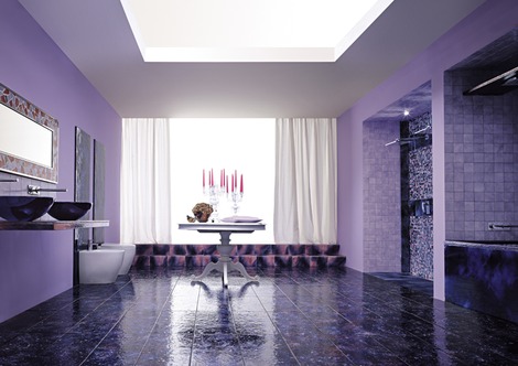 a whimsy purple bathroom with a floor done with patterned tiles, purple vessel sinks and a purple clad tub