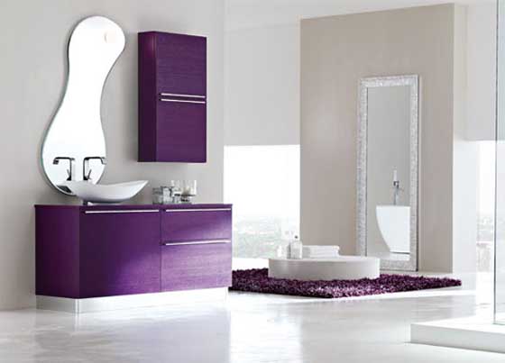 A purple and off white bathroom with clean lines and shapes, a catchy shaped mirror and a floating vanity