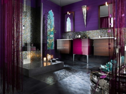 a bright purple bathroom with purple wallpaper, fuchsia touches and bright tiles in the shower space