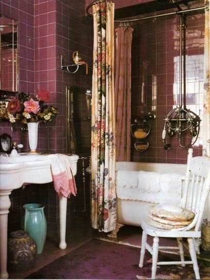 a shabby chic bathroom done in chocolate brown, purple and whites, floral textiles and a white vintage table