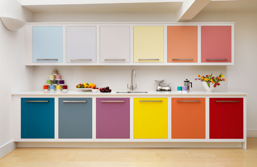 A contemporary rainbow kitchen with cabinets done in bold mismatching shades and uppers in more muted shades looks just jaw dropping
