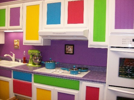 a colorful ktichen with bold panels and a purple countertop is a lovely idea done with much fun and whimsy