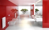 a unique red and white bathroom with a statement white and mirror wall, white appliances and a potted tree behind the tub