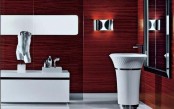 an exquisite burgundy bathroom with metallic touches and white appliances is a refined and chic space