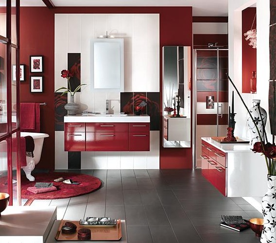 a minimalist red and white bathroom with sleek and minimal furniture, a free-standing tub and a red rug plus a touch of pattern