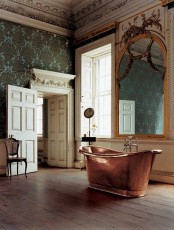 a lovely bathroom with a copper bathtub
