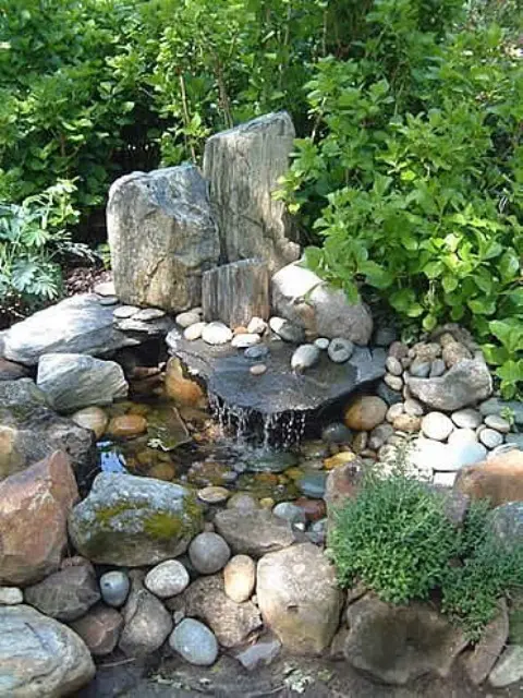 Several large rocks and a bunch of pebbles is more than enough  to construct a beautiful garden  waterfall.
